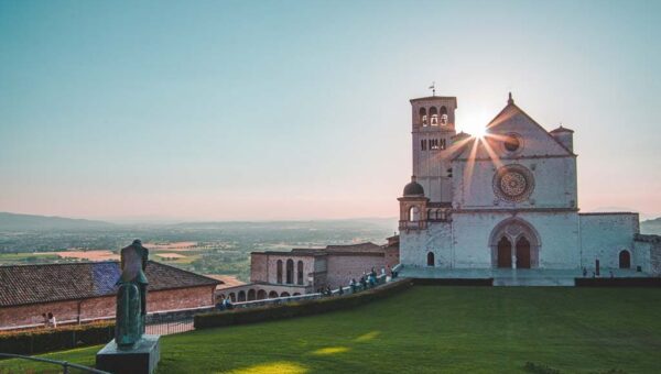 The sun rising behind a chapel in Assisi